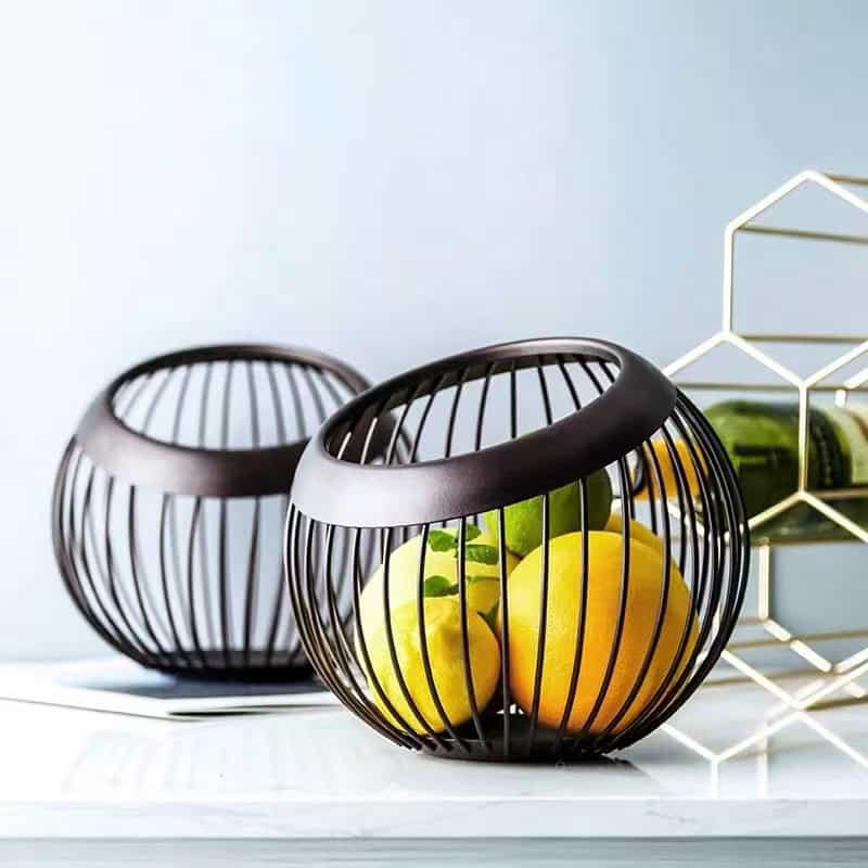 Juicy fresh lemons in modern black wire fruit basket for healthy living healthy lifestyle.