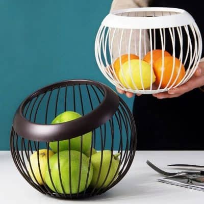 Decorative fruit basket with colorful apples, oranges, and lemons in modern wire containers for healthy eating or home decor.