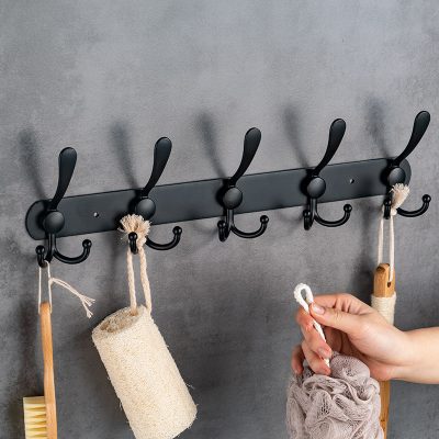 Black metal wall hook rack for organizing toiletries and accessories at Monalisa Medical Store.