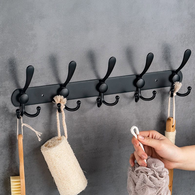 Black metal wall hook rack for organizing toiletries and accessories at Monalisa Medical Store.