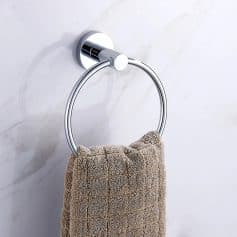 Polished chrome towel ring with beige textured towel on marble wall, bathroom accessory, modern bathroom decor, Monalisa Store, premium quality towel holder, elegant toilet paper holder for bathroom usage.