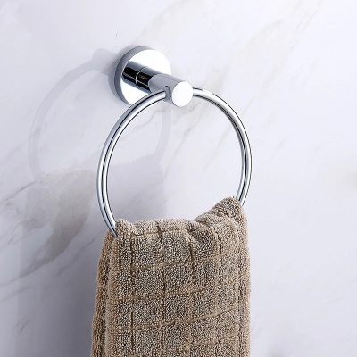 Polished chrome towel ring with beige textured towel on marble wall, bathroom accessory, modern bathroom decor, Monalisa Store, premium quality towel holder, elegant toilet paper holder for bathroom usage.