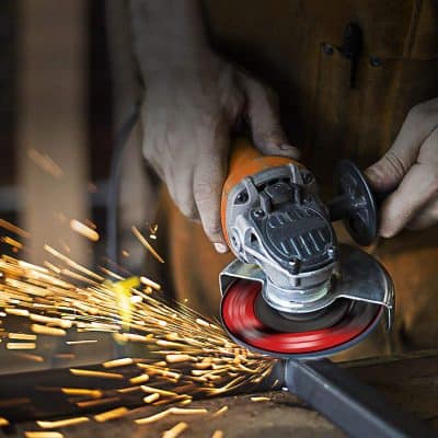 High-speed angle grinder cutting metal, sparks flying, close-up industrial work, safety gloves, power tool, professional craftsmanship, metal fabrication, heavy-duty grinding, efficient cutting tool, workshop environment.