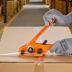 Sealing carton with tape dispenser in warehouse, packaging medical products at Monalisa Store, ensuring secure shipment and proper labeling for healthcare supplies.