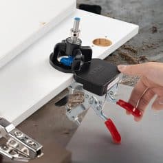 Precision woodworking router mounted on a white work surface, used for detailed craftsmanship or custom furniture making. Focus on high-quality tools for professional woodworking projects.