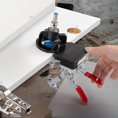 Precision woodworking router mounted on a white work surface, used for detailed craftsmanship or custom furniture making. Focus on high-quality tools for professional woodworking projects.