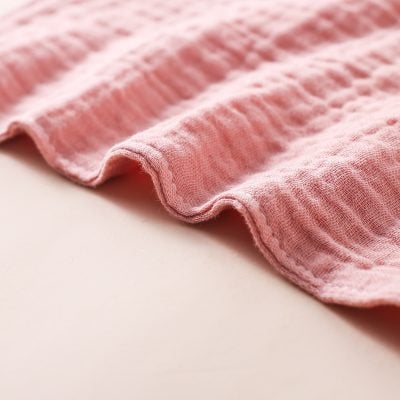 Soft pink fabric texture, close-up of a cozy blanket or towel for comfortable home textiles.
