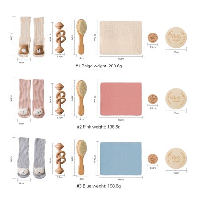 Beige baby socks with bear face design, wooden teether, natural bath brush, soft beige towel, round