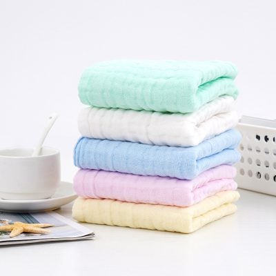 Soft pastel-colored towels stacked neatly, perfect for skincare or beauty treatments at Monalisa Store. Ideal for spas, salons, or personal use, offering comfort and luxury.