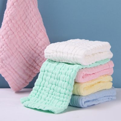 Fluffy pastel-colored bath towels stacked for sale at Monalisa Store, ideal for luxury and comfort in bathroom decor.