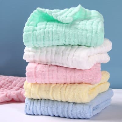 Soft pastel-colored baby blankets stacked, perfect for newborns and infants, ideal for photo props, nursery decor, and baby showers. Soft, gentle fabrics for delicate skin.
