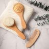 Soft natural wooden massage brushes and exfoliating scrubber with handle for skincare and beauty routines.