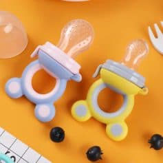 Baby bottle with soft silicone nipple on colorful animal-shaped holder, ideal for teething relief and babies' oral comfort, perfect for nursery and baby care.