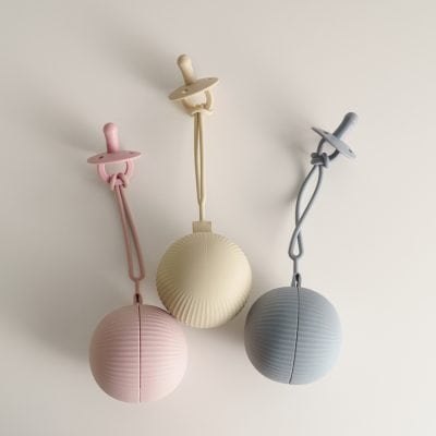 Colorful baby pacifier-themed pendant lights with textured spherical shades, perfect for nursery decor and modern interior design.