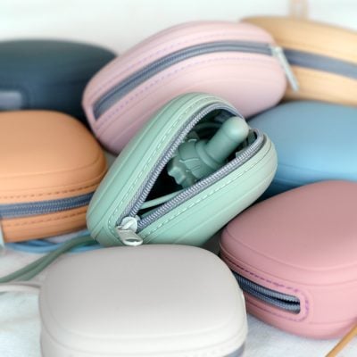 Earphone in pastel-colored carrying case, portable accessories for eye health, Monalisa Medical store, stylish and compact electronic device storage, trendy optometry accessories.