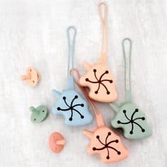 Colorful silicone ear atresia blockers with flexible loops, suitable for ear health and medical use in audiology clinics, featuring playful design and skin-safe materials.