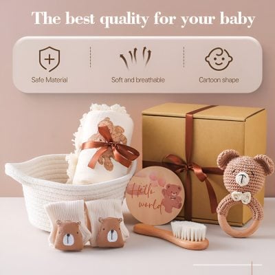 Soft baby accessories with teddy bear design, including socks, a blanket, and a teething ring, presented with gift box and decorative items for newborn care and baby gift sets.