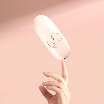 Wireless LED light therapy device for skin care and rejuvenation, stylish white design, easy-to-use controls, ideal for facial treatments.