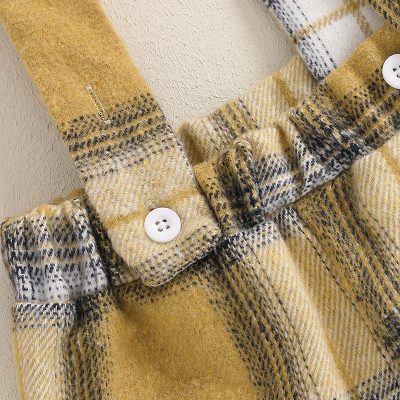 Soft yellow and black checkered plaid fabric showing detailed stitching and white buttons, perfect for stylish winter apparel or cozy clothing from Monalisa Store.