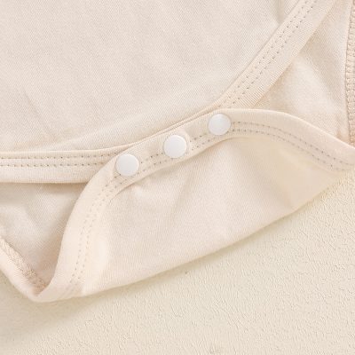Soft beige nursing bra with snap closures, comfortable for postpartum and maternity wear, offering support and easy breastfeeding access.