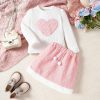 Cute pink and white children's outfit featuring a heart-patterned sweater and matching skirt, perfect for stylish kids' fashion at Monalisa Store.