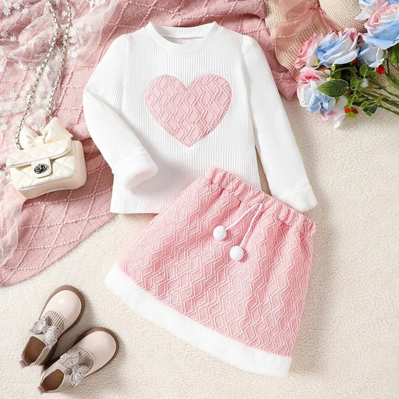 Cute pink and white children's outfit featuring a heart-patterned sweater and matching skirt, perfect for stylish kids' fashion at Monalisa Store.