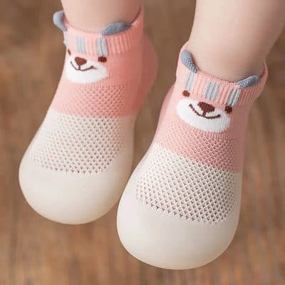 Soft pink toddler shoes with bear face design, breathable mesh material, and playful ankle socks for kids' comfort and style.