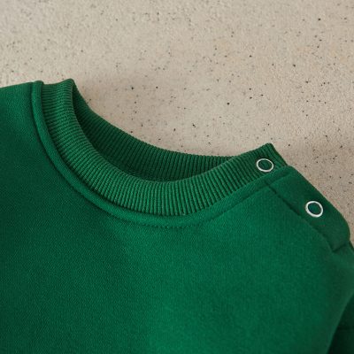 Comfortable green sweatshirt with snap buttons for casual wear and optical comfort, perfect for everyday fashion and eye protection options at Monalisa Medical Store, designed for durability and style.