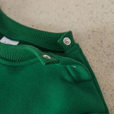 Button-up green polo shirt with ribbed collar and metal snap buttons for neck closure. Perfect casual wear for men and women available at Monalisa Store.