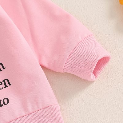 Comfy pink sweatshirt with black text, casual everyday wear for women and men, soft cotton fabric, stylish and cozy, perfect for a casual outing or lounging at home, trending streetwear fashion piece.