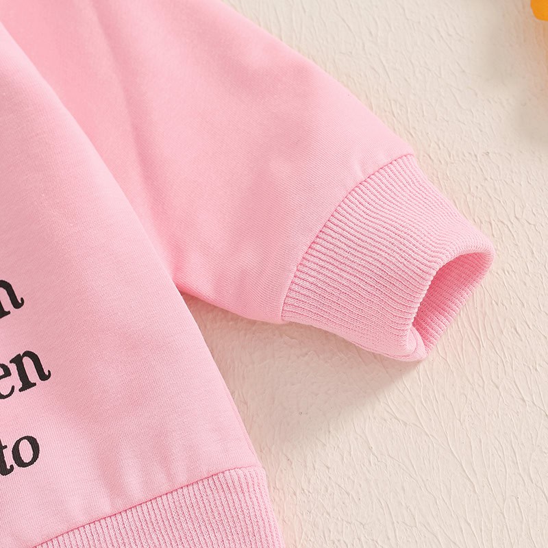 Comfy pink sweatshirt with black text, casual everyday wear for women and men, soft cotton fabric, stylish and cozy, perfect for a casual outing or lounging at home, trending streetwear fashion piece.