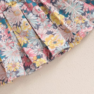 Floral fabric, colorful floral print on cotton, perfect for fashion, sewing, or home decor projects, bright and vibrant design for stylish accessories or garment making.