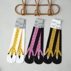White and black socks with yellow tiger stripe pattern, playful fashion accessories, stylish animal print socks, trendy unisex socks for casual wear.