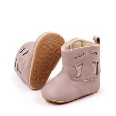 Soft pink baby boots with cut-out leaf design, ideal for infants and toddlers, featuring comfortable slip-resistant soles and durable material for stylish, supportive footwear.