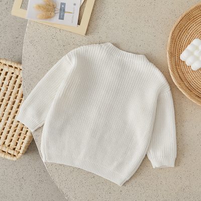 Soft white knit sweater for women, perfect for casual or elegant outfits, made from high-quality materials for comfort and style. Ideal for fall and winter fashion needs.