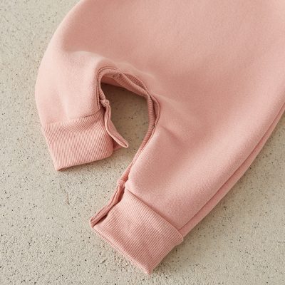 Soft pink children's sweatshirt with ribbed cuffs and zipper detail, perfect for comfy casual wear.