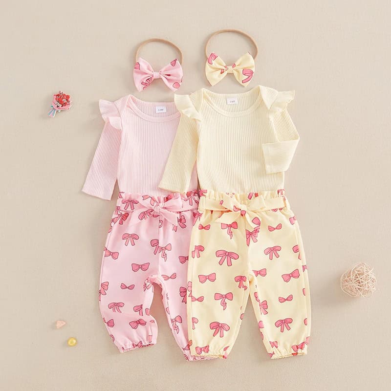 Pink and cream children's pajamas with bow patterns and matching headbands, perfect for cozy sleepwear and stylish loungewear for girls.
