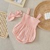 Pink gingham baby romper with matching bow headband, on beige surface, trendy infant clothing for summer and spring, Monalisa Store.