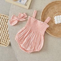 Pink gingham baby romper with matching bow headband, on beige surface, trendy infant clothing for summer and spring, Monalisa Store.