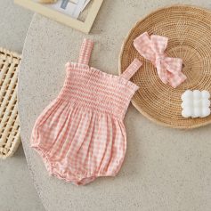 Soft pink gingham baby romper with smocked waist, perfect for stylish and comfortable children's clothing.