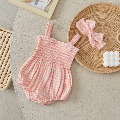 Soft pink gingham baby romper with smocked waist, perfect for stylish and comfortable children's clothing.