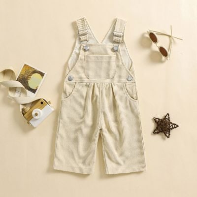 Soft beige corduroy overalls with front pocket and adjustable straps, perfect for kids' fashion and outdoor wear.