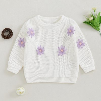 White knitted sweater with lavender flower appliqués, perfect for spring, casual wear, and cozy style. Fashionable and comfortable, ideal for women seeking floral design in their wardrobe.
