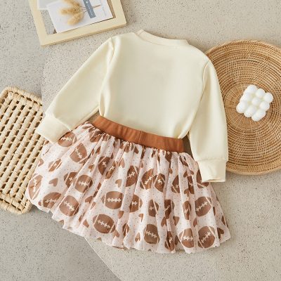 Soft cream sweatshirt with football-themed pink and brown tulle skirt for girls, stylish and comfortable casual wear suitable for kids, perfect for playdates and family outings.