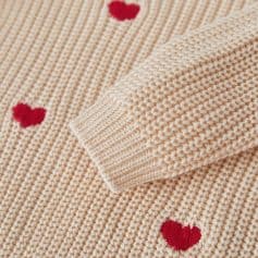 Knitted sweater with red heart designs, cozy and fashionable, perfect for winter wear, high-quality craftsmanship and soft fabric, ideal for stylish casual outfits for women and men.