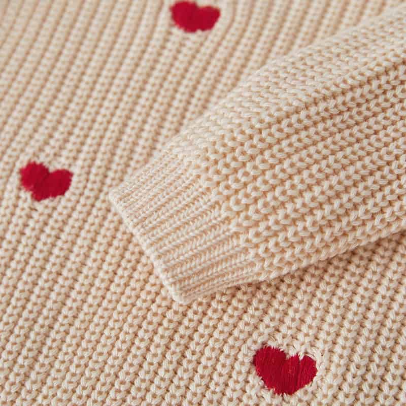 Knitted sweater with red heart designs, cozy and fashionable, perfect for winter wear, high-quality craftsmanship and soft fabric, ideal for stylish casual outfits for women and men.