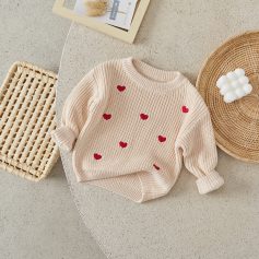 Soft pink knit sweater with red heart embroidery, ideal for cozy fashion and casual wear. Perfect for adding a sweet touch to your wardrobe.