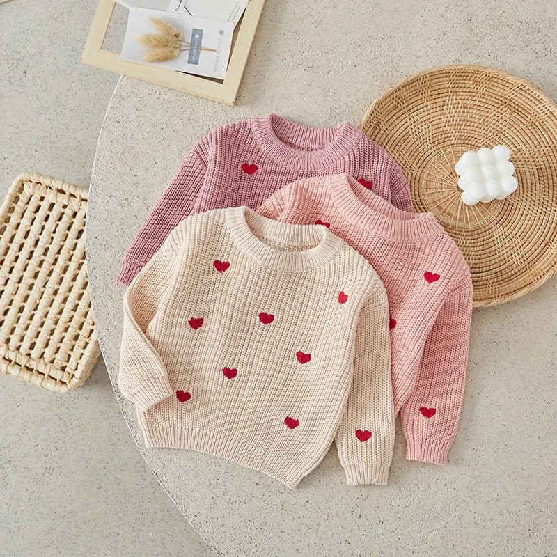Soft knit sweaters for women, featuring heart embroidery, in pastel pink and cream colors, perfect for cozy and stylish winter wear. Ideal for casual and chic outfits.