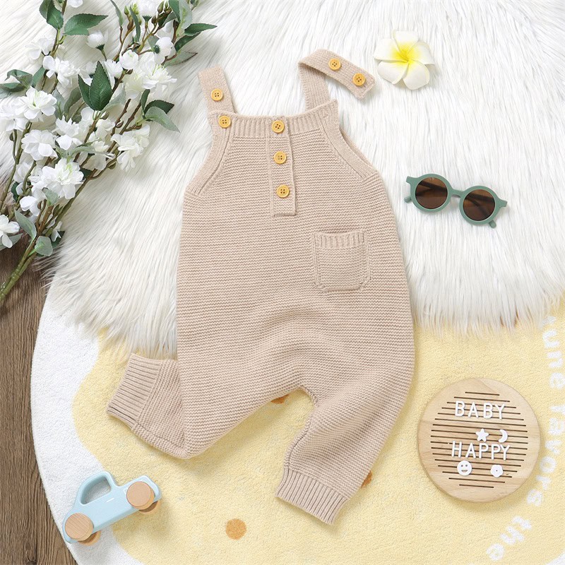 Knitted baby romper with buttons and a small pocket, beige color, stylish and comfortable infant clothing for casual wear and photoshoots.