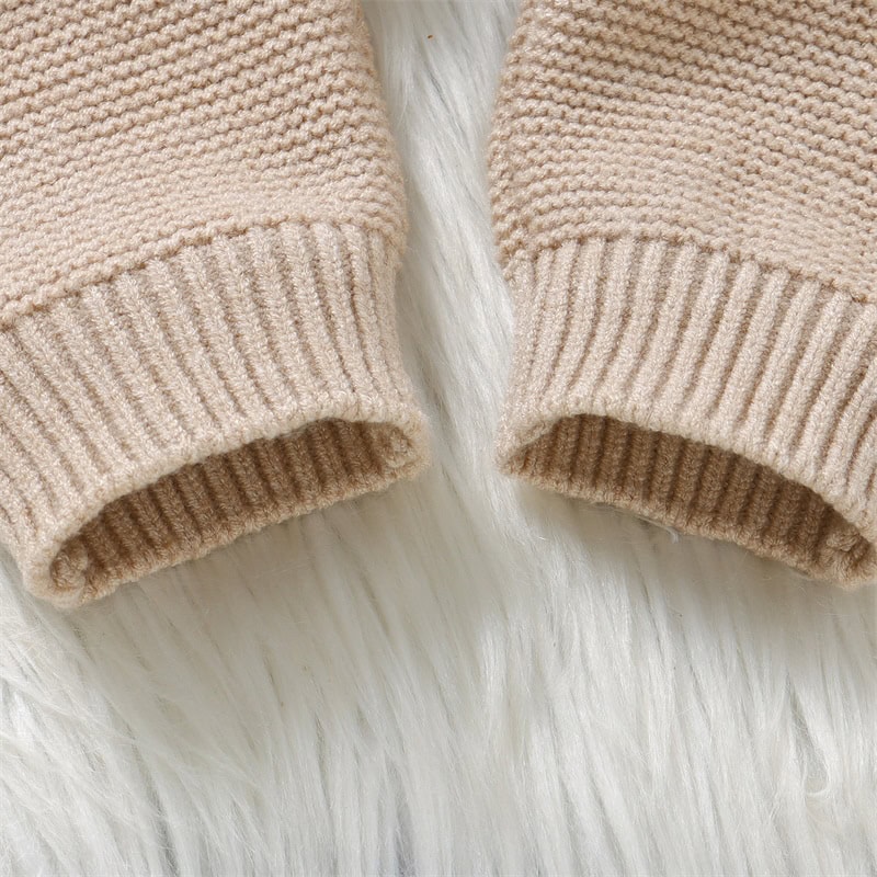 Soft beige knitted sweater sleeve close-up, comfortable and stylish knitwear. Perfect for casual wear and layering for fall and winter.